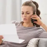 woman talking on phone about underpaid claim